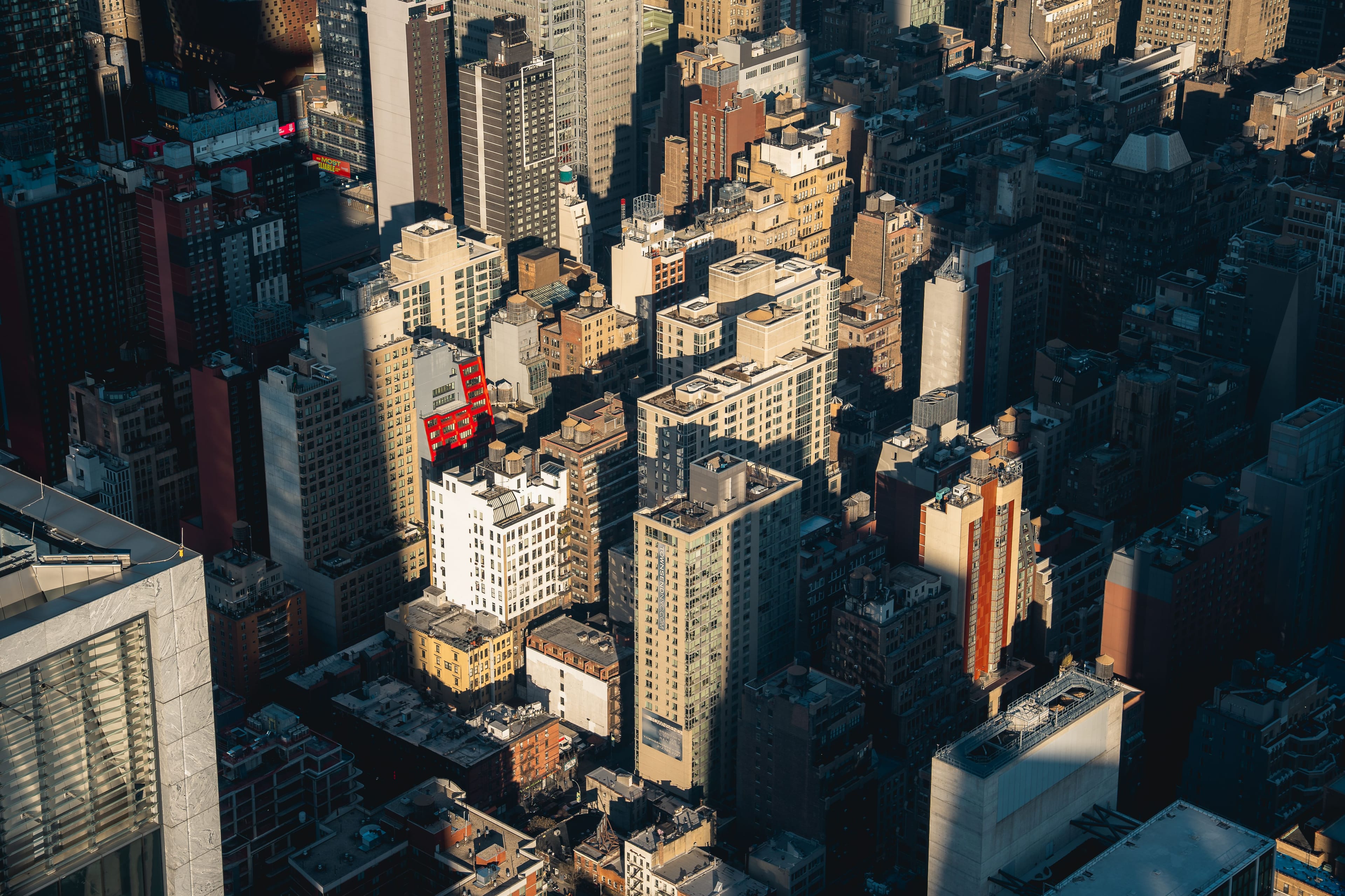 Aerial view of a dense city skyline in late-day light